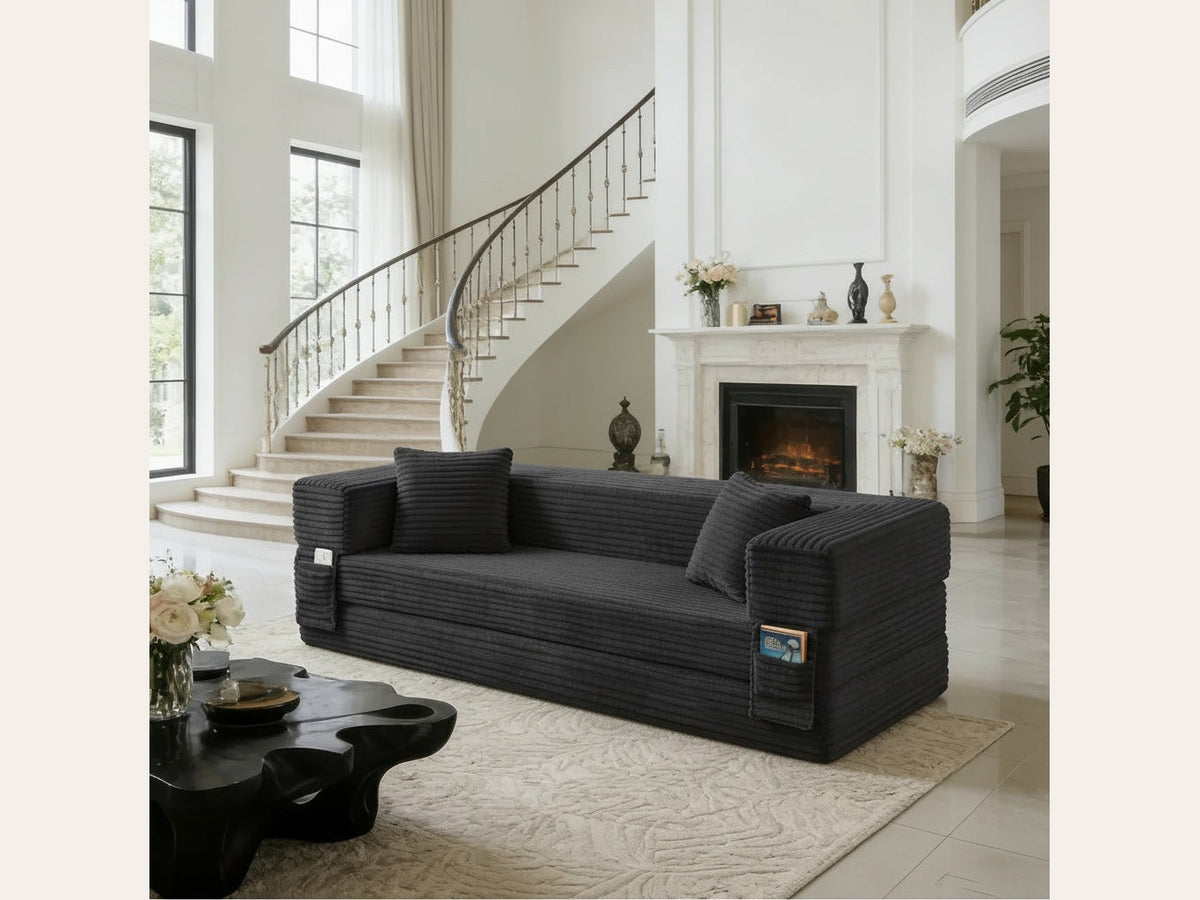 Pouf lit pliant en velours côtelé, coloris gris, en situation, cheminée