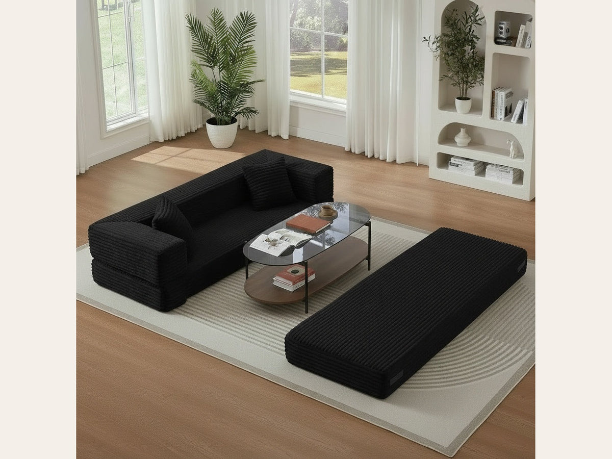 Pouf lit pliant en velours côtelé, coloris noir, en situation, salon