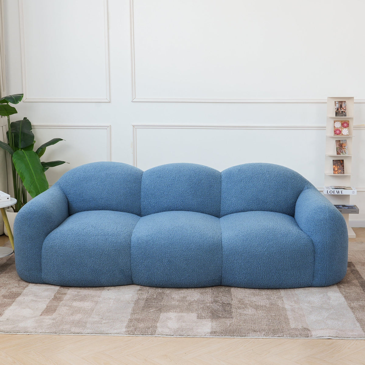 Canapé nuage 3 places avec accoudoirs, tissu bouclé bleu azur, en situation dans un intérieur