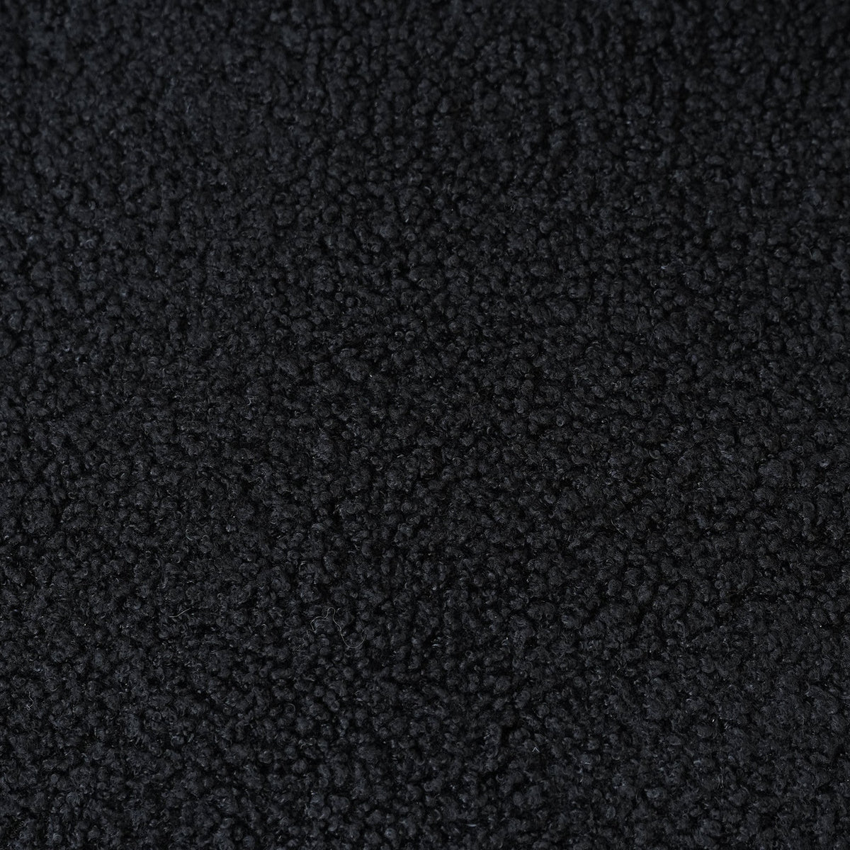 Canapé nuage 3 places avec accoudoirs, gros plan sur le tissu bouclé noir charbon