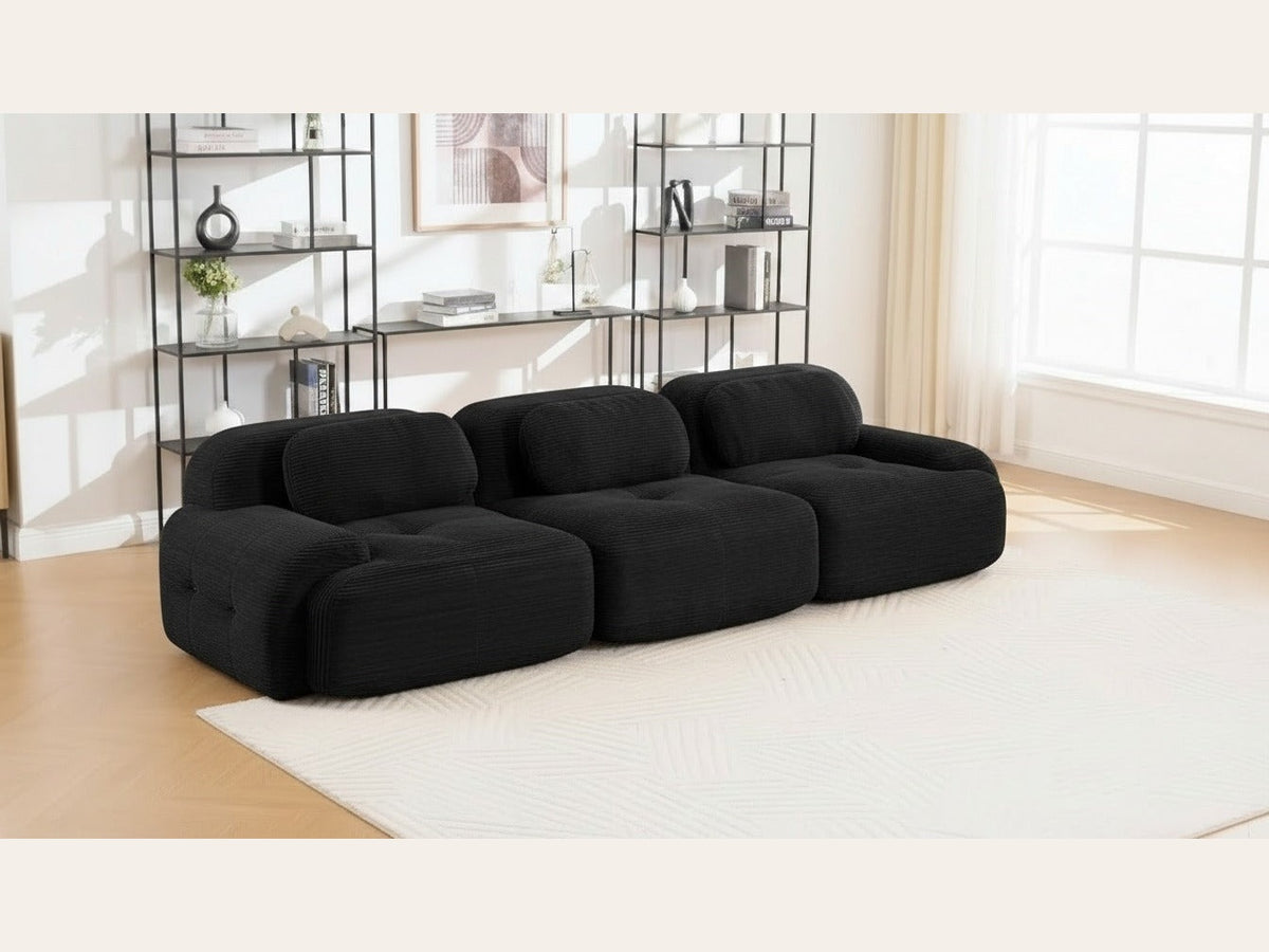 Canapé modulaire 3 places noir, de trois quarts dans un salon