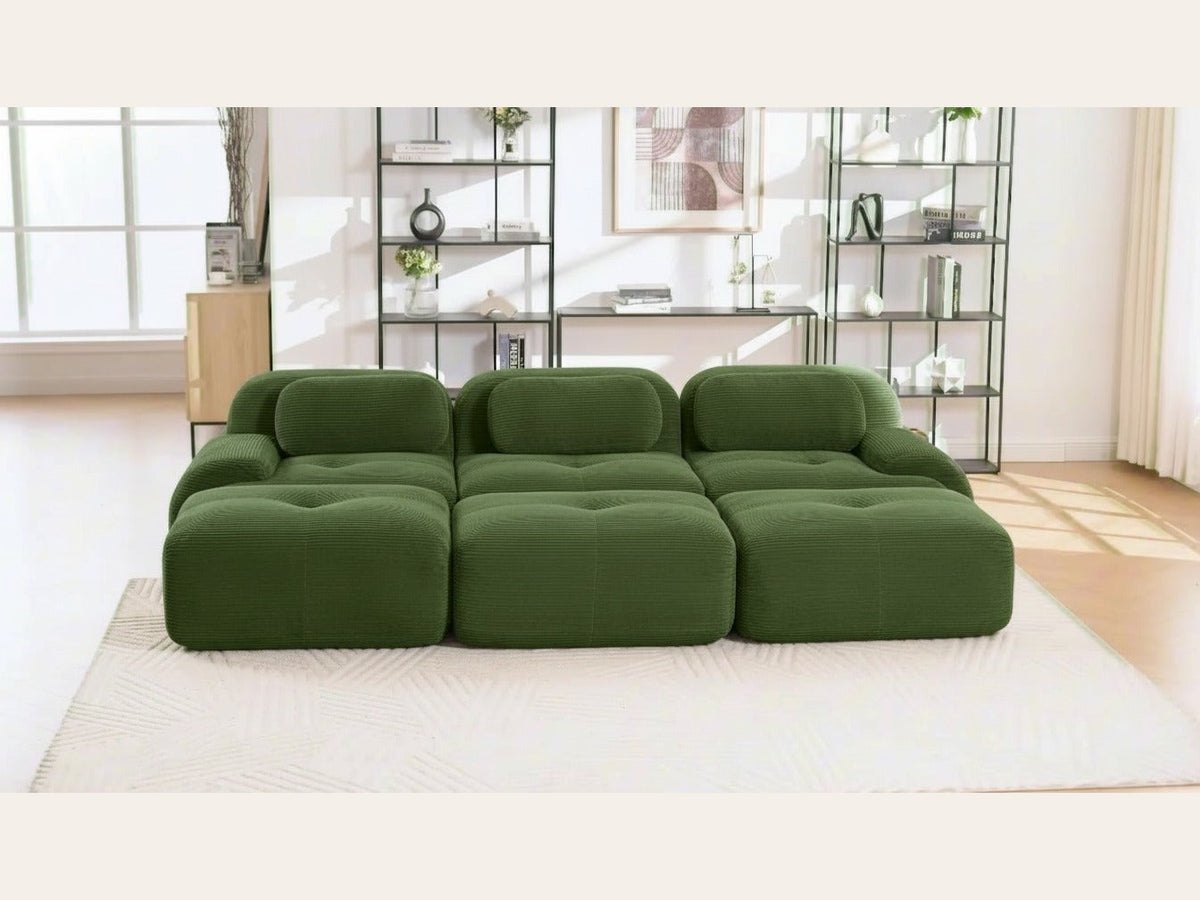 Canapé profond 3 places vert, de face dans un salon
