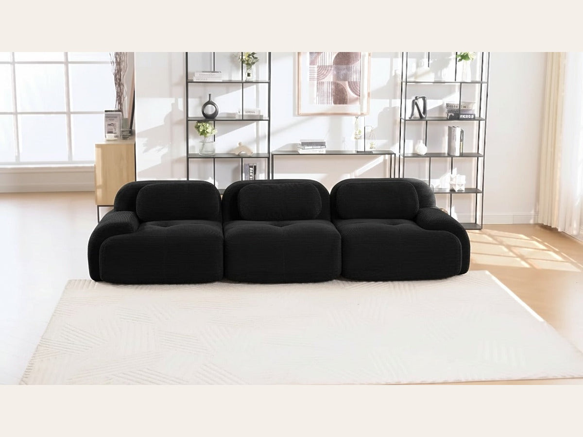 Canapé modulaire 3 places noir, de face dans un salon