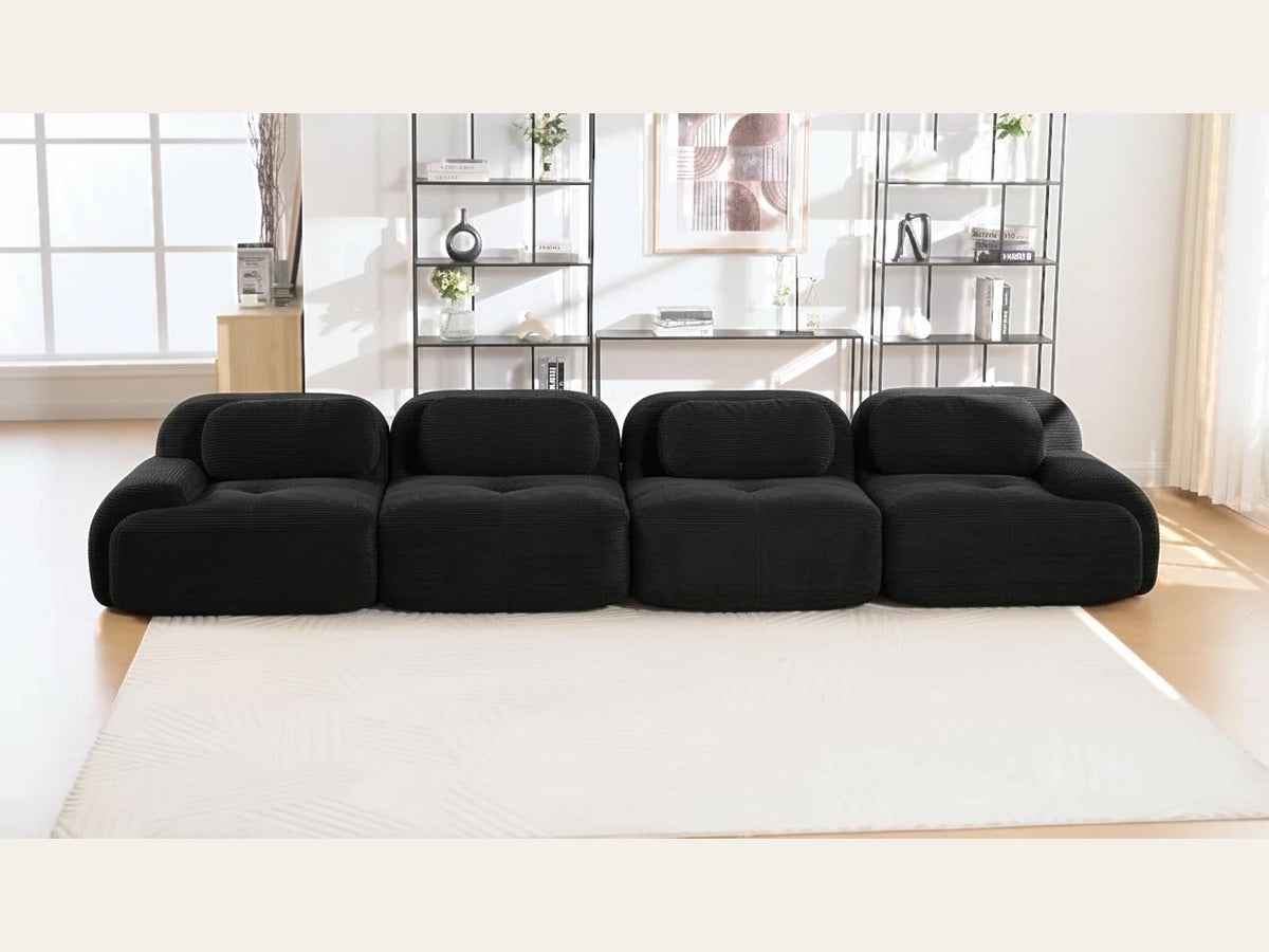 Canapé 4 places velours côtelé noir, de face dans un salon