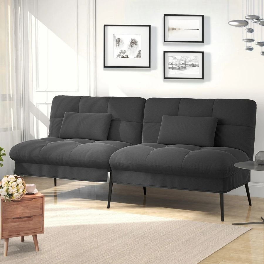 Canapé convertible en velours, coloris gris anthracite, dans une pièce